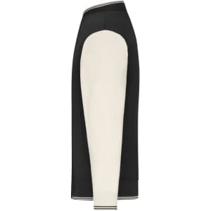 A varsity jacket featuring a black body and cream-coloured sleeves, with ribbed cuffs and a logo.