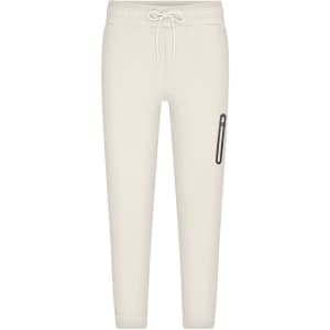 Men's interlock pants in a light cream colour, featuring a drawstring waist and a side pocket with branding.