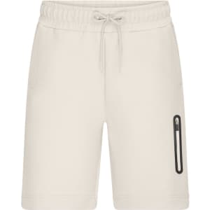 Light-coloured men's interlock shorts featuring an elastic waistband and side pocket with a logo.