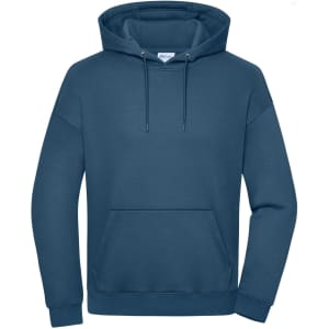 An oversized unisex hoody in a deep blue tone, featuring a front pocket and a hood. It has a logo on the label.