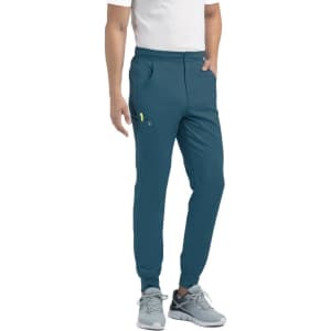 A pair of teal joggers with a half elastic waistband, featuring side pockets and a small logo.