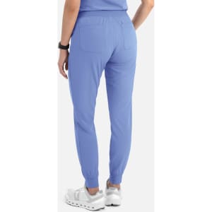 A pair of women's joggers in light blue with elastic cuffs and back pockets, featuring a logo.