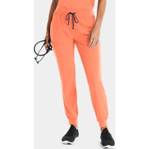 Bright orange women's jogger pants with a drawstring waist and pockets, featuring a logo on the waistband.