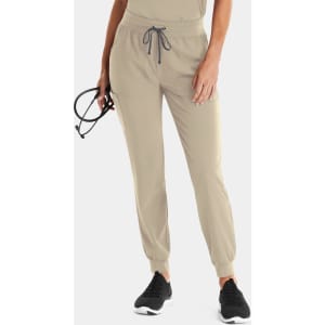 A pair of women's joggers in light beige with an elastic waistband and adjustable drawstring. They have a logo and pockets.