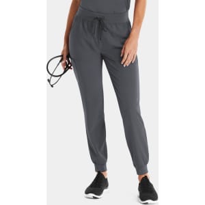 A pair of women's jogger pants in dark grey with elastic cuffs and a drawstring waist, held by a model with glasses.