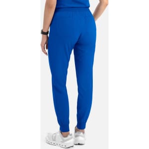A pair of women's joggers in bright blue, featuring a fitted design and ribbed cuffs, displayed from the back.