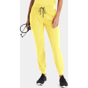 A pair of bright yellow women's jogger pants with a drawstring waistband, featuring a logo and worn with black sneakers.