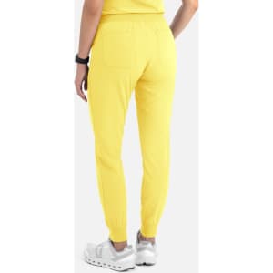A pair of women's joggers in bright yellow, featuring an elastic waist and tapered cuffs, with two back pockets.