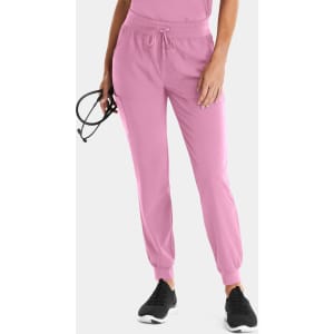 A pair of women's joggers in pink, featuring a drawstring waist and elastic cuffs, with a logo present.