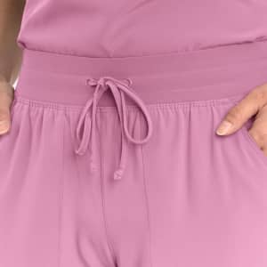 A close-up of women's joggers in soft pink, featuring a drawstring waist and side pockets.