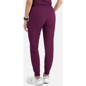 A pair of women's jogger pants in a deep plum colour with elastic cuffs and two back pockets.