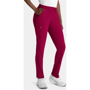 A pair of women's skinny pull-on pants in a vibrant magenta, featuring a drawstring waist and pockets.