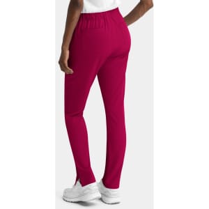 A pair of women's skinny pull-on pants in a vibrant fuchsia colour, featuring a mid-rise waist and elastic waistband.