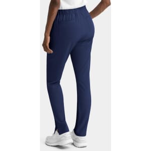 Navy women's skinny pull-on pants with a fitted design and elastic waistband, featuring pockets and side slits.