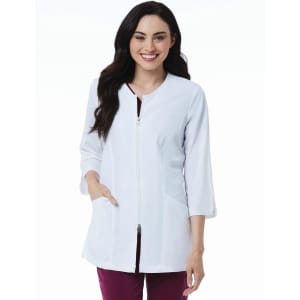 A woman wearing a white 3/4 sleeve lab jacket with a zip and side pockets, featuring a logo.