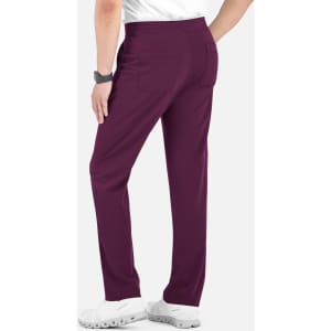 A person wearing purple cargo pants with a half elastic waistband, paired with white footwear. Branding is visible.
