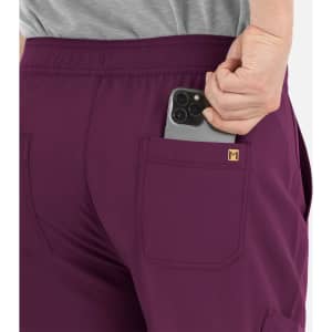 A pair of purple cargo pants featuring a half elastic waistband and a pocket holding a smartphone.