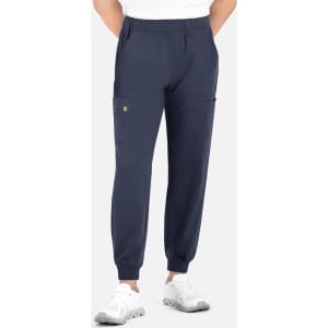 A pair of navy joggers with a full elastic waistband and side pockets, worn by a model.
