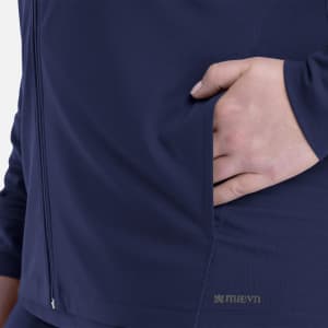 A navy women's hooded zip front jacket with a hand in the side pocket and a small logo near the hem.
