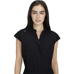 A black jumpsuit with short sleeves, a collar, and a front pocket, featuring a logo.