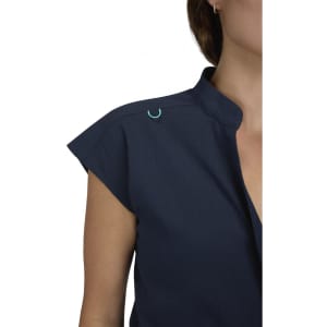 A navy blue jumpsuit featuring a collar and cap sleeves, with a decorative logo on the shoulder.