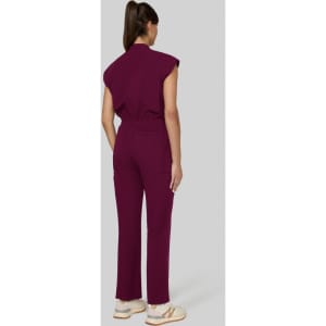 A maroon jumpsuit with short sleeves and a relaxed fit, featuring a cinched waist and straight leg design.
