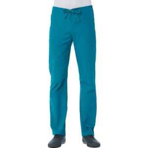 A unisex pull-on pant in teal with a drawstring waist and pockets. The model is wearing black shoes.