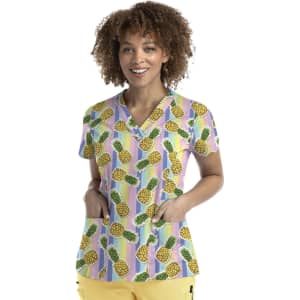A women's V-neck top featuring a colourful pineapple print on a striped background with two front pockets.