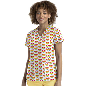 A women's V-neck top featuring a multicoloured heart print, paired with yellow pants. Branding is visible.