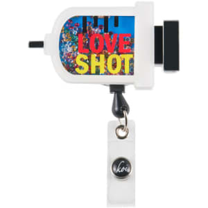 A white shaker badge features colourful gemstones and a branding logo, with a clip for attachment.