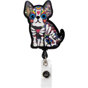 A colourful dog-shaped badge with a patterned design, featuring sparkly embellishments and a clear attachment.