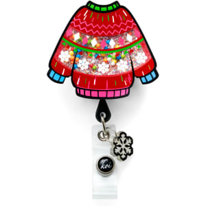 A red festive sweater badge featuring multicoloured sequins and a snowflake charm, with a logo at the bottom.