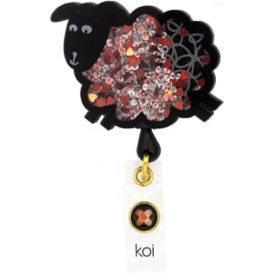 A black sheep-shaped badge with red and silver sequins, featuring a gold attachment and a small branding tag.