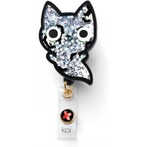 A sparkly, black-and-white cat-shaped badge with glitter, featuring a clear attachment with a logo.