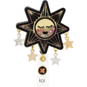 A star-shaped badge with a smiling sun design, featuring glittery star charms in gold, silver, and white. It includes a logo.