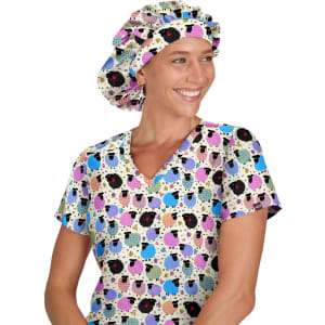 A woman wearing a colourful bouffant cap with a playful pattern, paired with a matching patterned top.