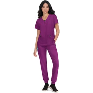 A scrub outfit in vibrant purple featuring a top with pockets and matching pants, complemented by a logo.