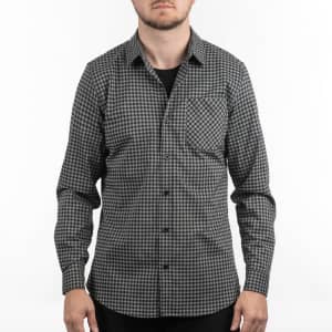 A black and white checkered patterned shirt with a single pocket and long sleeves. It features a logo.