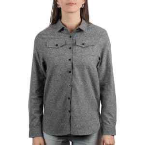 A grey extra soft solid flannel shirt with a button-up front and two chest pockets. It has a logo on the side.