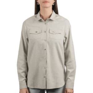 A light grey ladies button-up flannel shirt featuring two chest pockets and a collar. It has a subtle logo on it.