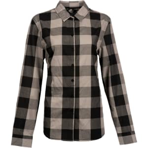 A long sleeve shirt in a black and grey buffalo check pattern, featuring a button-up front and collar. It has a logo.