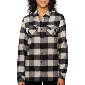 A long sleeve, black and cream check flannel shirt with two chest pockets and a button-up front. It has a logo visible.