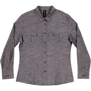 A long sleeve chambray shirt in a grey tone with two chest pockets and button-up front, featuring a logo.