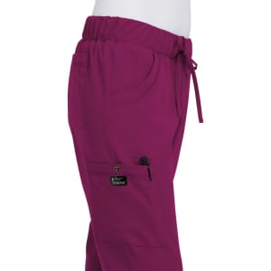 A pair of fuchsia pink pants with an elastic waistband, featuring pockets and a logo patch.