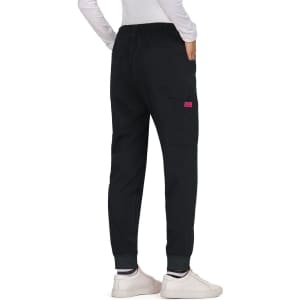 Black Aster Pants with an elastic waistband and a single pocket, styled with fitted cuffs and worn with white shoes.