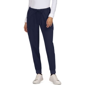 Navy Aster Pants with a drawstring waist and pockets, paired with a white top and casual shoes.
