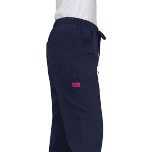 A pair of navy Aster Pants with pockets and an elastic waistband, featuring a pink branding tag.