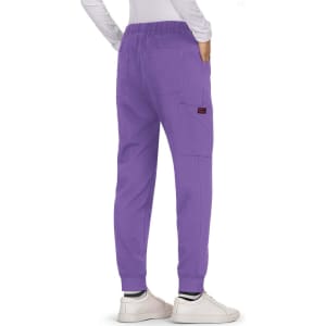 A pair of purple Aster Pants featuring side pockets and cuffed ankles, worn with white shoes.