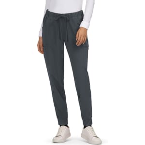 A pair of dark grey Aster Pants with adjustable drawstring and side pockets, worn with white sneakers.