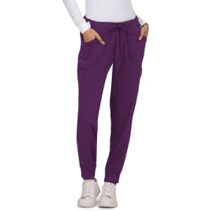 A pair of purple pants with pockets and a drawstring waistband, worn with a fitted white top and shoes.